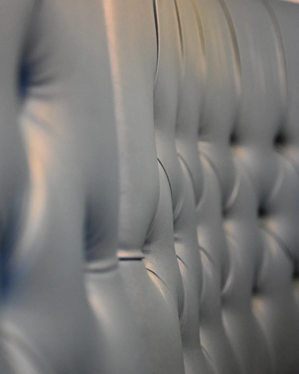 Placeholder: a detailed upholstered headboard, standing in for a machine-embroidered headboard panel made with the Monolit Method.