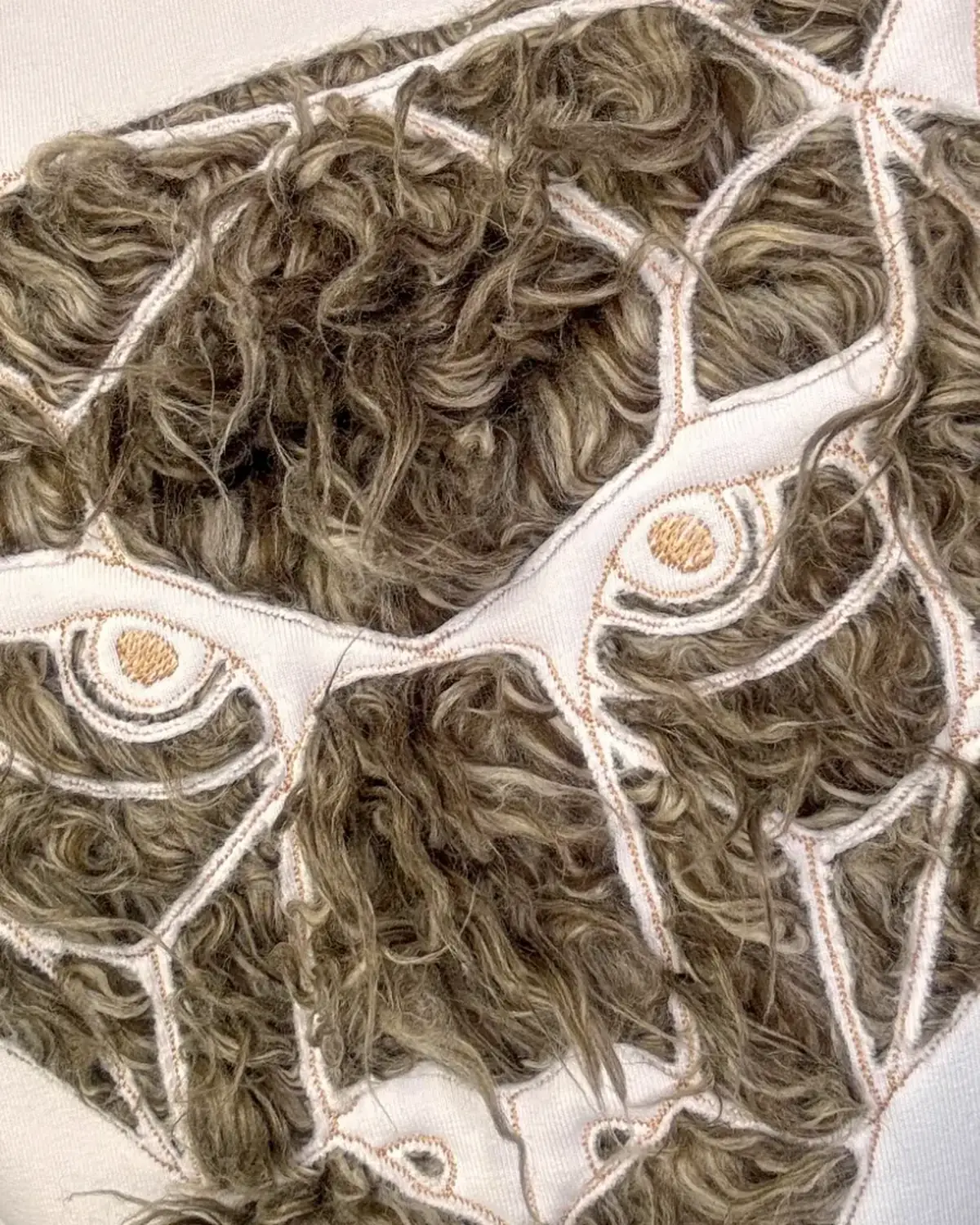 Brown faux fur Monolit Panther pillow cover, the panther motif machine-embroidered, the same construction as Migula Studio's BESTIA.